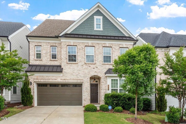 113 Mazarin Ln, Cary, NC 27519 - view of front of home with a standing seam roof, brick siding, concrete driveway, an attached garage, and metal roof