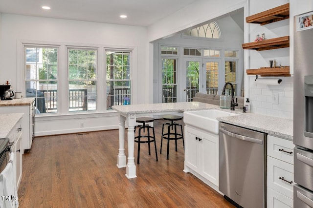 100 Bradborne Cir, Clayton, NC 27520 - kitchen featuring open shelves, dark wood-style floors, white cabinetry, a sink, and appliances with stainless steel finishes