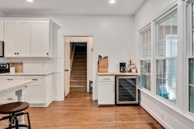 100 Bradborne Cir, Clayton, NC 27520 - bar with beverage cooler, recessed lighting, decorative backsplash, and light wood-type flooring