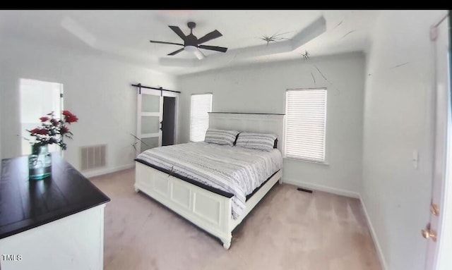 100 Bradborne Cir, Clayton, NC 27520 - bedroom with baseboards, light colored carpet, a barn door, and visible vents