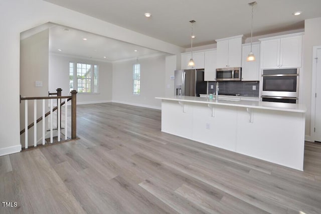 1020 Kentlands Dr, Durham, NC 27713 - kitchen featuring light countertops, light wood finished floors, and stainless steel appliances