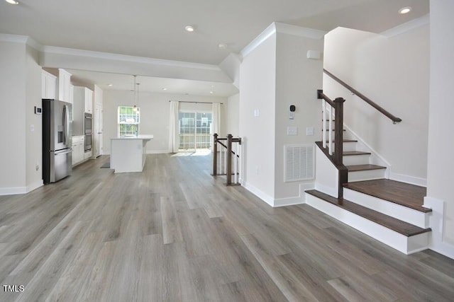 1020 Kentlands Dr, Durham, NC 27713 - unfurnished living room with recessed lighting, crown molding, visible vents, and light wood-type flooring