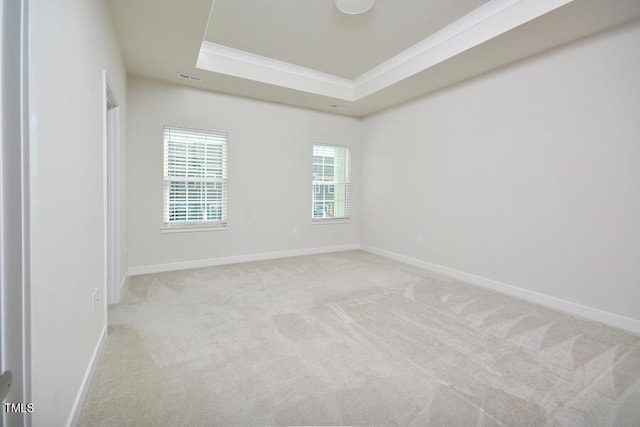 1020 Kentlands Dr, Durham, NC 27713 - empty room featuring a tray ceiling, baseboards, light colored carpet, and crown molding