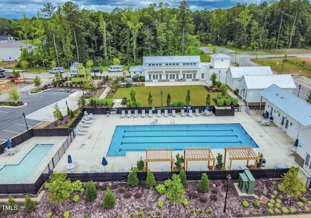 1020 Kentlands Dr, Durham, NC 27713 - community pool with fence, a lawn, a patio area, and a wooded view