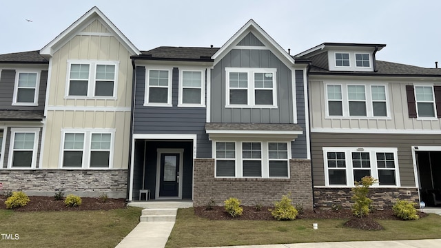803 Courting St, Apex, NC 27523 - view of property with board and batten siding, stone siding, and roof with shingles