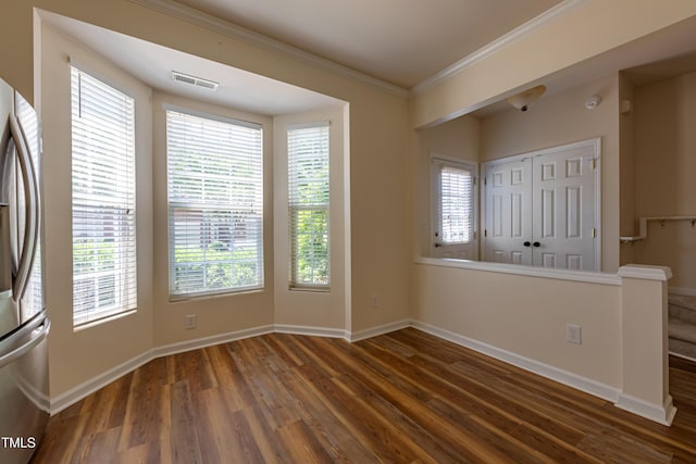 5209 Echo Ridge Rd, Raleigh, NC 27612 - unfurnished dining area featuring wood finished floors, ornamental molding, healthy amount of natural light, and baseboards