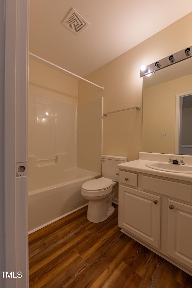 5209 Echo Ridge Rd, Raleigh, NC 27612 - bathroom featuring vanity, wood finished floors, toilet, and washtub / shower combination