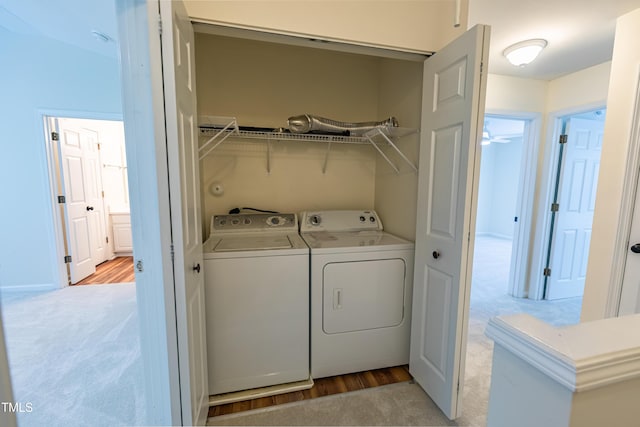5209 Echo Ridge Rd, Raleigh, NC 27612 - laundry area featuring washing machine and dryer, light carpet, and light wood-type flooring