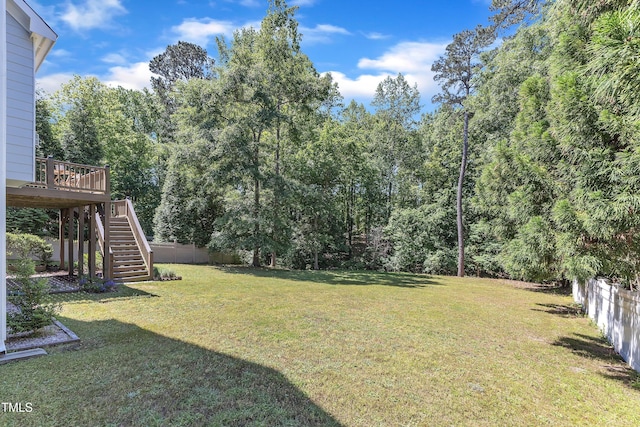 view of yard featuring fence, stairs, and a deck