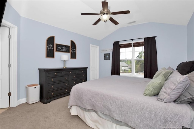 bedroom featuring lofted ceiling, light colored carpet, baseboards, and a ceiling fan