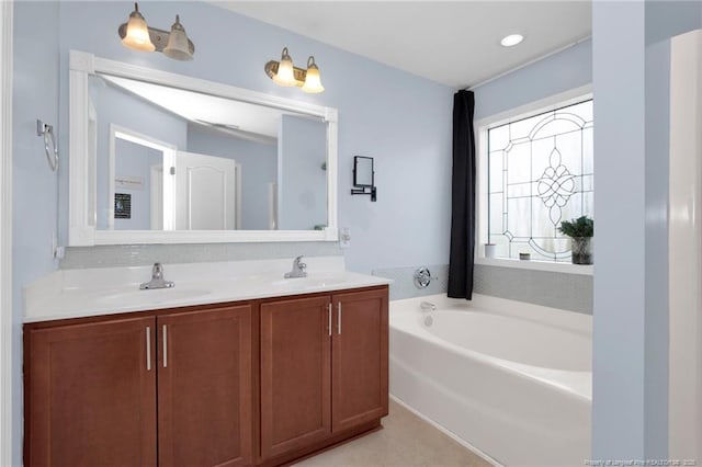 bathroom with a garden tub and double vanity