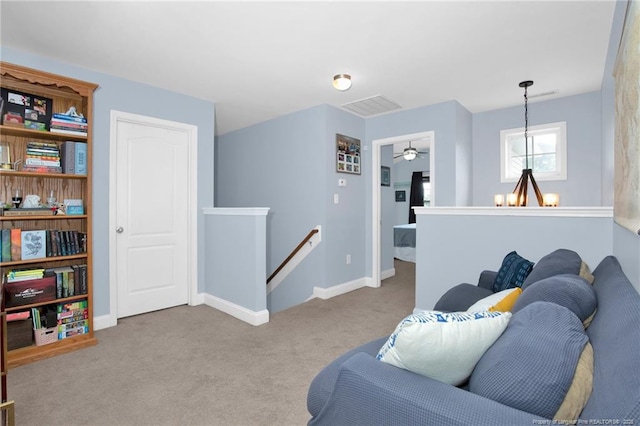 carpeted living room featuring baseboards and a ceiling fan