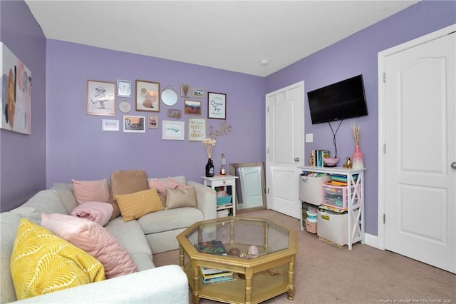 carpeted living room with baseboards