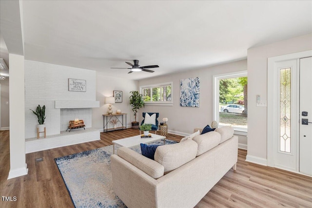 106 Circle Dr, Mebane, NC 27302 - living room with a fireplace, wood finished floors, baseboards, and ceiling fan
