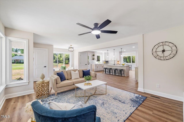 106 Circle Dr, Mebane, NC 27302 - living area featuring light wood finished floors, baseboards, a ceiling fan, and visible vents