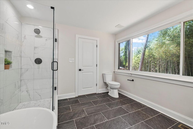 106 Circle Dr, Mebane, NC 27302 - bathroom featuring a shower stall, a healthy amount of sunlight, baseboards, and visible vents