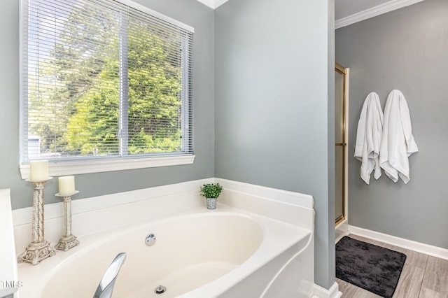 5413 Botany Bay Dr, Raleigh, NC 27616 - bathroom with a bath, plenty of natural light, a stall shower, and wood finished floors