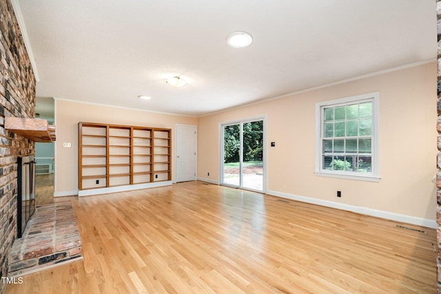 unfurnished living room featuring a fireplace, ornamental molding, light wood-style flooring, baseboards, and recessed lighting