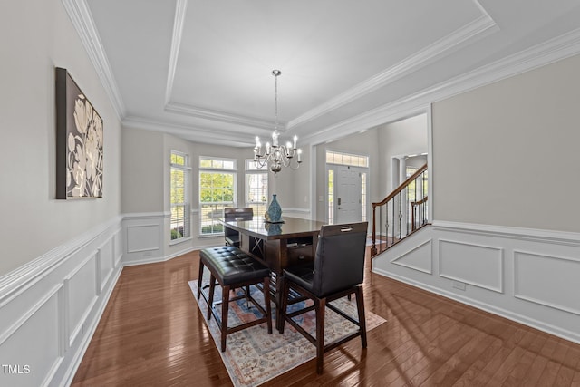 316 Hilliard Forest Dr, Cary, NC 27519 - dining area featuring a chandelier, a decorative wall, dark wood-style flooring, and a tray ceiling