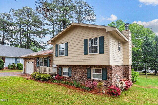 3309 Teal Dr SW, Wilson, NC 27893 - tri-level home with brick siding, driveway, a garage, and a front lawn