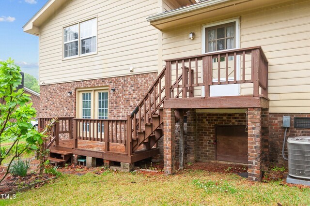 3309 Teal Dr SW, Wilson, NC 27893 - rear view of house with central air condition unit, a yard, a deck, and brick siding