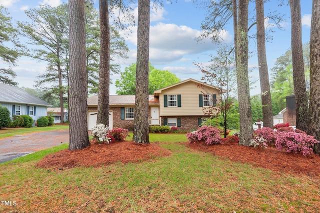 3309 Teal Dr SW, Wilson, NC 27893 - split level home with brick siding, a front yard, an attached garage, and aphalt driveway