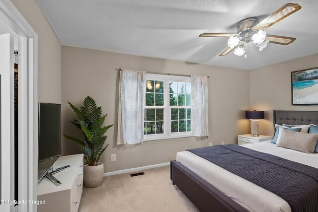 3309 Teal Dr SW, Wilson, NC 27893 - bedroom with light carpet, baseboards, a ceiling fan, and visible vents