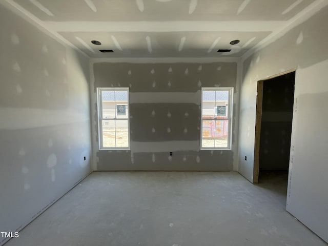 unfurnished room featuring plenty of natural light and concrete floors