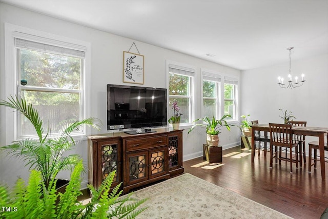 1041 Cotulla Dr, Morrisville, NC 27560 - living room with baseboards, wood finished floors, and a notable chandelier