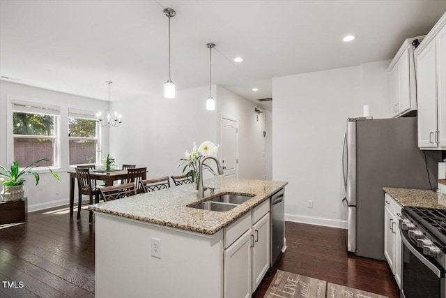 1041 Cotulla Dr, Morrisville, NC 27560 - kitchen with an inviting chandelier, dark wood-style flooring, baseboards, a sink, and stainless steel appliances