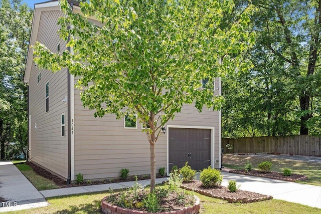 1041 Cotulla Dr, Morrisville, NC 27560 - view of side of property with concrete driveway, fence, and a garage