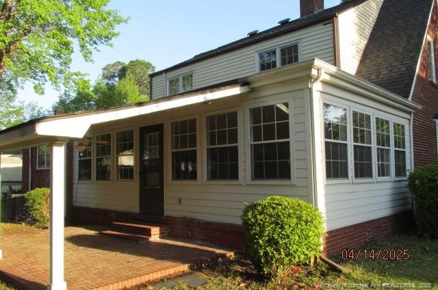 203 W 16th St, Lumberton, NC 28358 - rear view of property with a chimney