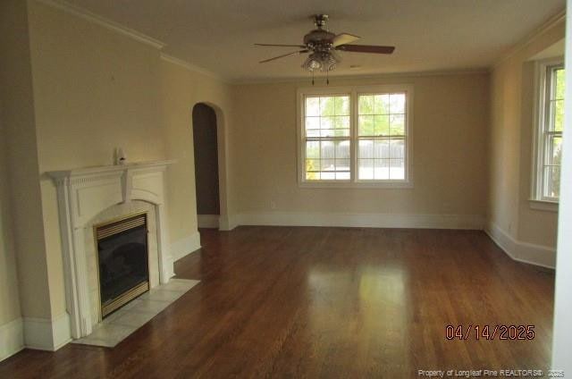 203 W 16th St, Lumberton, NC 28358 - unfurnished living room featuring arched walkways, ornamental molding, ceiling fan, wood finished floors, and a fireplace with flush hearth