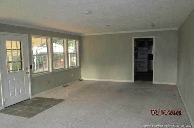 203 W 16th St, Lumberton, NC 28358 - empty room featuring baseboards, ornamental molding, and carpet floors