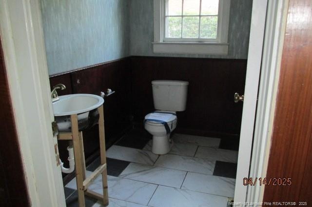 203 W 16th St, Lumberton, NC 28358 - bathroom featuring toilet and a wainscoted wall