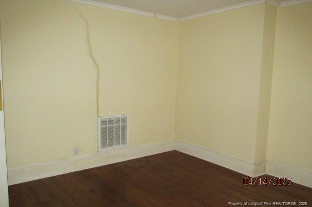 203 W 16th St, Lumberton, NC 28358 - empty room with visible vents, baseboards, crown molding, and dark wood finished floors