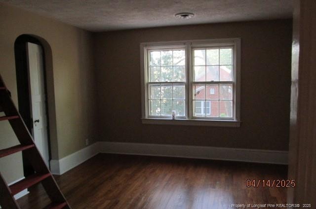 203 W 16th St, Lumberton, NC 28358 - spare room with plenty of natural light, dark wood-type flooring, baseboards, and a textured ceiling