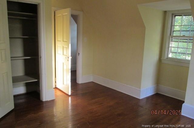 203 W 16th St, Lumberton, NC 28358 - unfurnished bedroom featuring baseboards, multiple windows, and wood finished floors