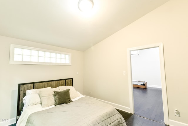 6409 Lakeland Dr, Raleigh, NC 27612 - bedroom featuring lofted ceiling, baseboards, and dark wood-type flooring