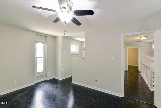 6409 Lakeland Dr, Raleigh, NC 27612 - spare room featuring dark wood-type flooring, a ceiling fan, and baseboards