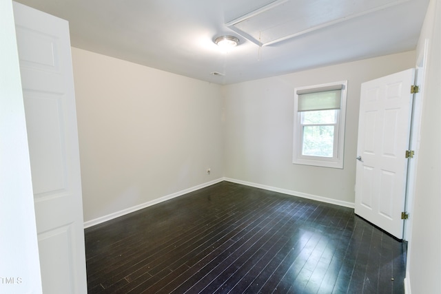 6409 Lakeland Dr, Raleigh, NC 27612 - unfurnished room with attic access, dark wood finished floors, and baseboards