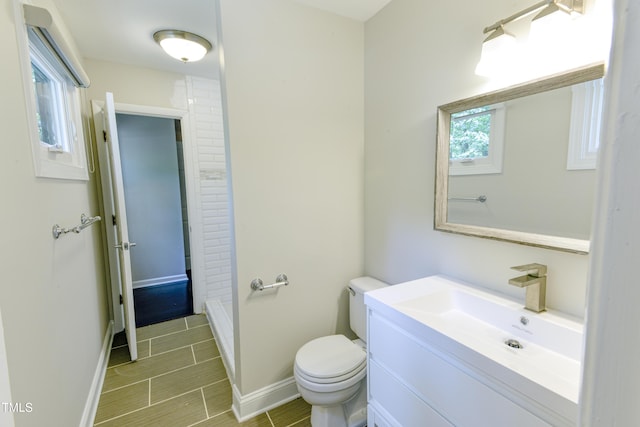 6409 Lakeland Dr, Raleigh, NC 27612 - bathroom with toilet, baseboards, a shower, and vanity