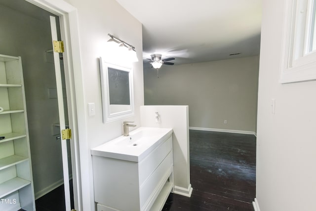 6409 Lakeland Dr, Raleigh, NC 27612 - bathroom featuring a ceiling fan, wood-type flooring, vanity, and baseboards
