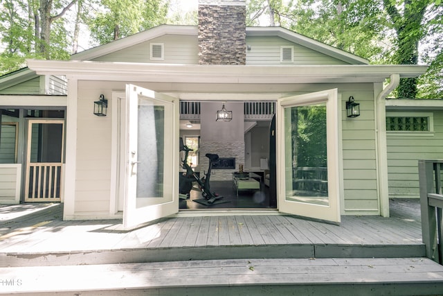 6409 Lakeland Dr, Raleigh, NC 27612 - view of exterior entry with a deck and a chimney