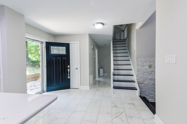 6409 Lakeland Dr, Raleigh, NC 27612 - foyer featuring light marble finish flooring, stairs, and baseboards