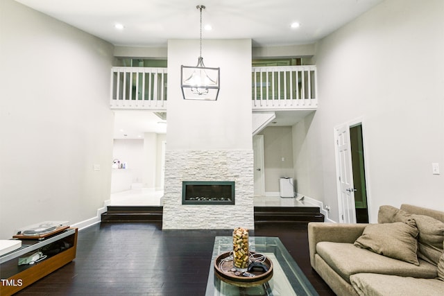 6409 Lakeland Dr, Raleigh, NC 27612 - living area with a chandelier, stairway, a high ceiling, dark wood-style floors, and baseboards
