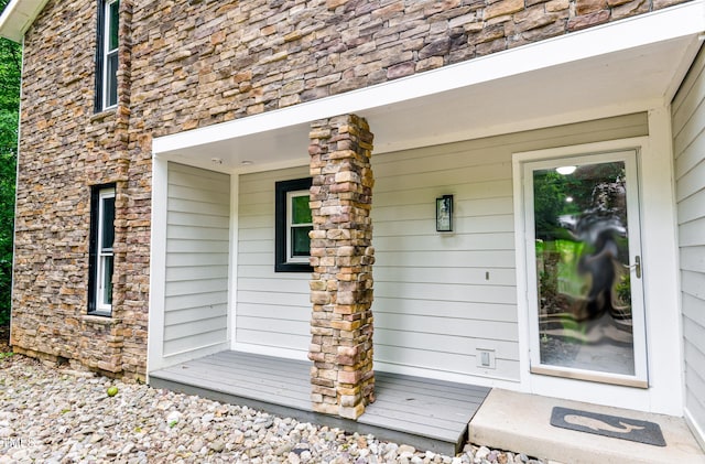 6409 Lakeland Dr, Raleigh, NC 27612 - doorway to property featuring stone siding and covered porch