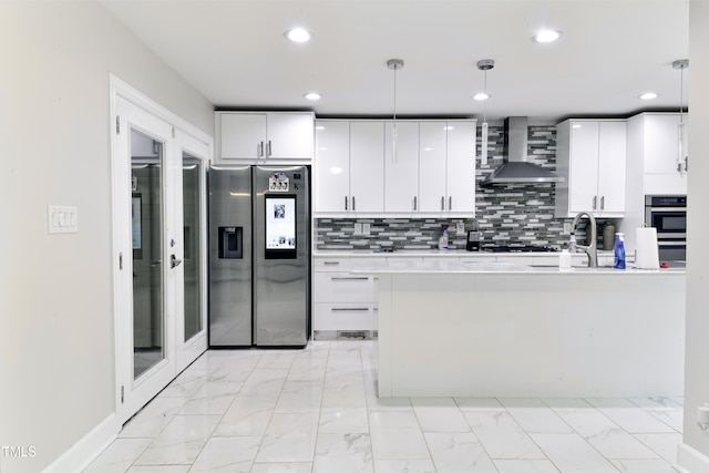 6409 Lakeland Dr, Raleigh, NC 27612 - kitchen with stainless steel refrigerator with ice dispenser, wall chimney exhaust hood, light marble finish floors, a sink, and recessed lighting