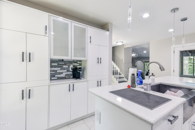 6409 Lakeland Dr, Raleigh, NC 27612 - kitchen featuring backsplash, pendant lighting, white cabinets, glass insert cabinets, and recessed lighting