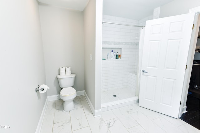 6409 Lakeland Dr, Raleigh, NC 27612 - bathroom featuring marble finish floors, a tile shower, baseboards, and toilet